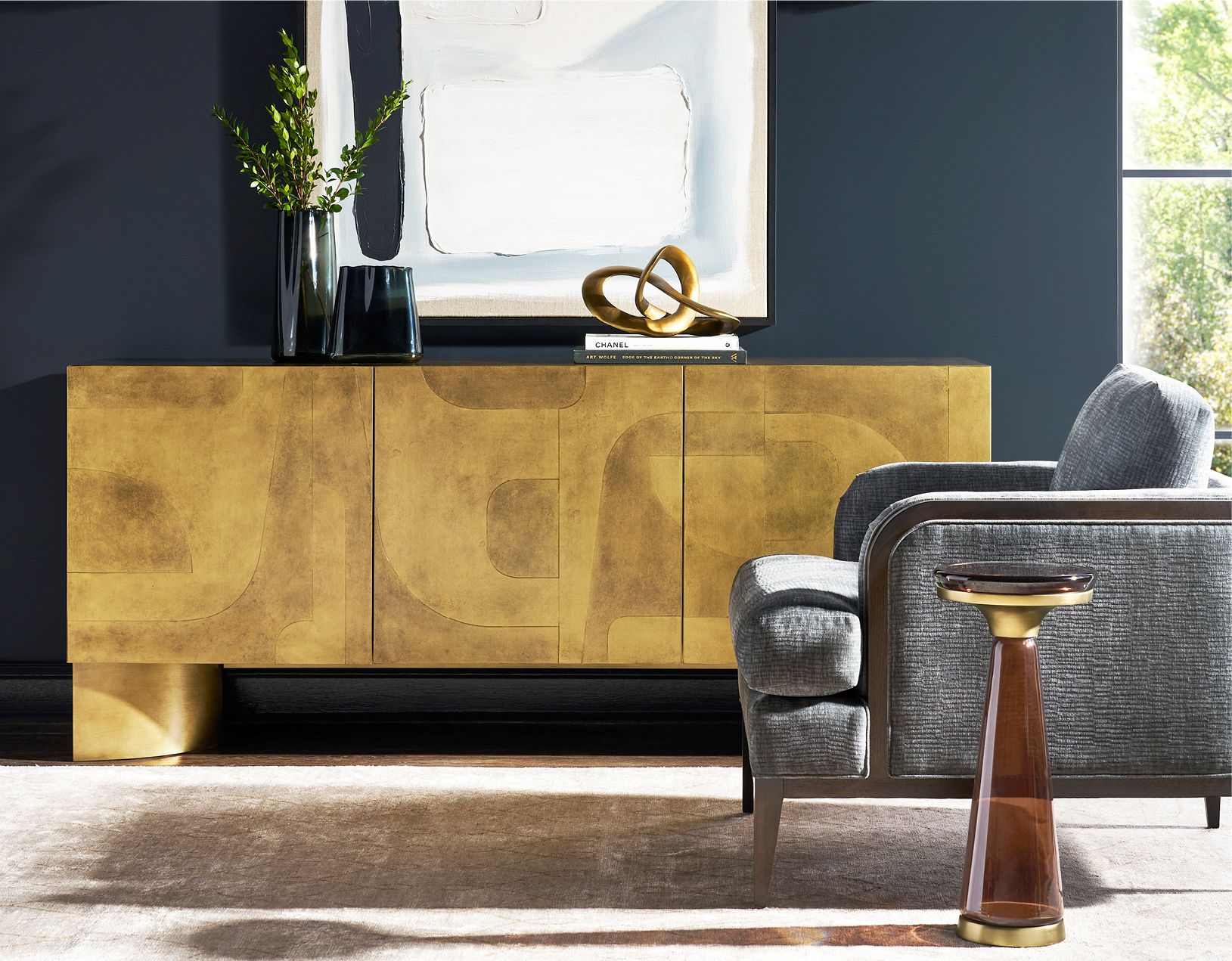 A gold-leaf credenza and upholstered chair from the Stocked Styles collection